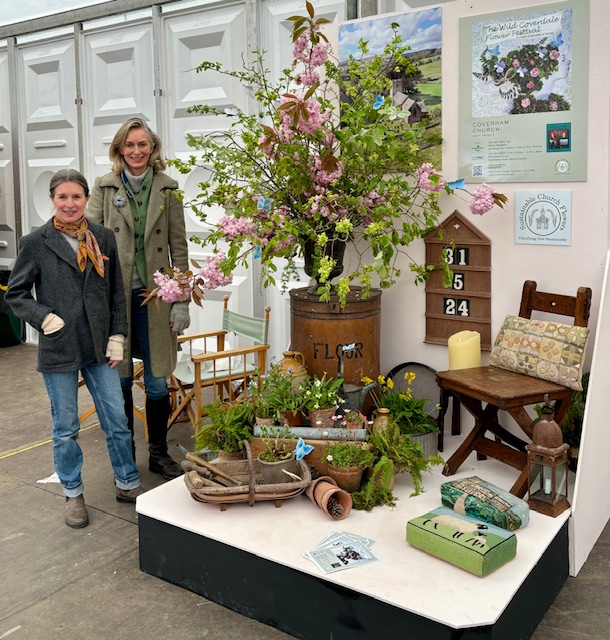two women stood with sustainable flower display